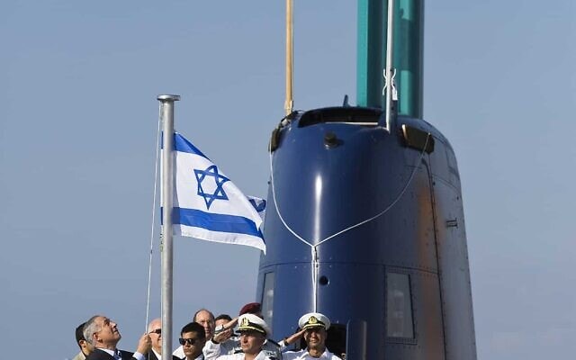 בנימין נתניהו מרים את דגל ישראל ב-23 בספטמבר 2014, בעת טקס קבלת הצוללת אח"י תנין, אחת מהצוללות שנרכשו מטיסנקרופ בגרמניה (צילום: AP Photo/Amir Cohen)