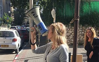 סיגל קסלר עם המגאפון, מול ביתו של נתן אשל (צילום: אמיר בן-דוד) סיגל קסלר עם המגאפון, מול ביתו של נתן אשל (צילום: אמיר בן-דוד)