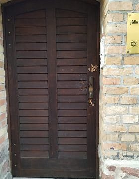 הדלת מנוקבת חורי הירי בבית הכנסת בהאלה (צילום: יעקב שוורץ)