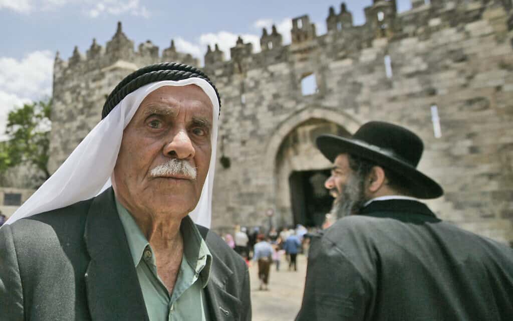 Palestinian man and Ultra-Orthodox Jews at the Damascus Gate (צילום: Abir sultan/Flash 90)