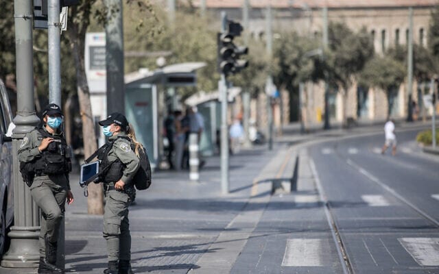 שוטרות על רקע שוק מחנה יהודה הסגור ביום הראשון של הסגר המהודק (צילום: Yonatan Sindel/Flash90)