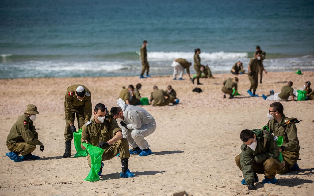 חיילים אוספים זפת בחוף פלמחים, 22 בפברואר 2021 (צילום: יונתן זינדל/פלאש90)