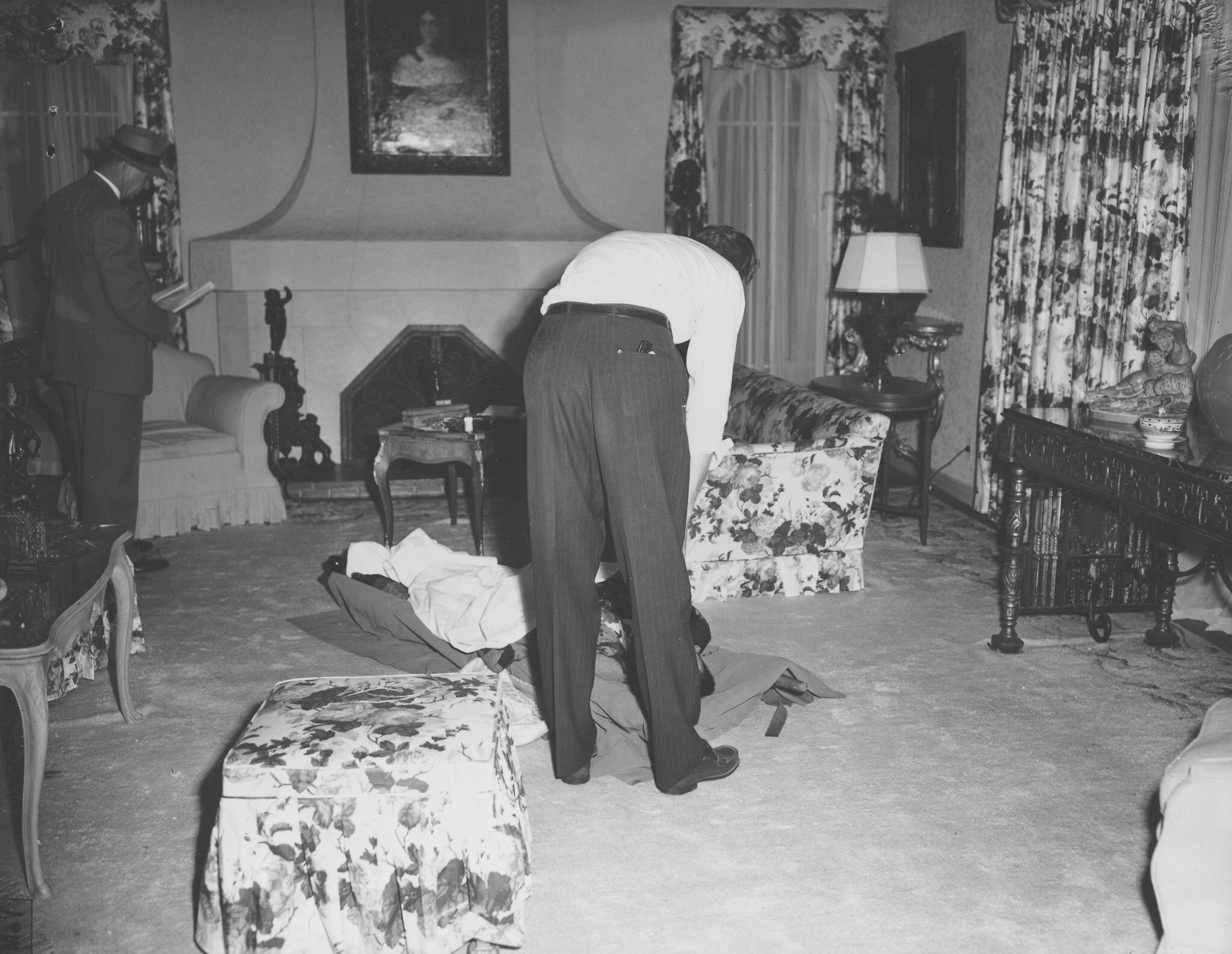 חוקר מקרי מוות רוכן מעל גופתו של באגסי סיגל, 21 ביוני 1947 (צילום: AP)