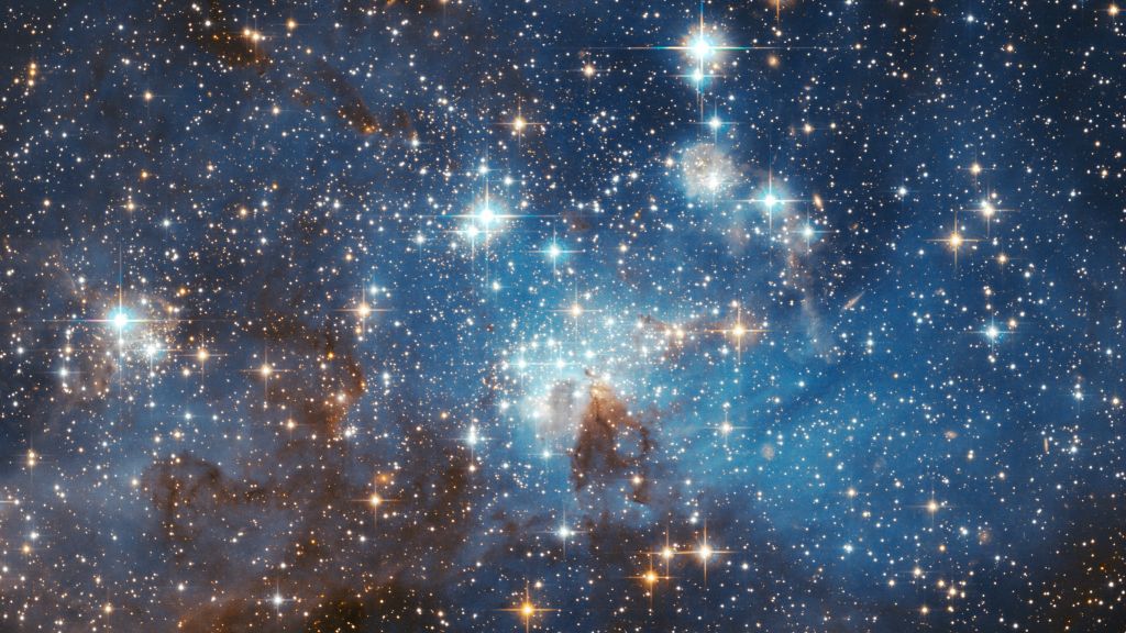 תמונה של &quot;תינוקיית הכוכבים&quot; LH 95 בענן מגלן הגדול, שהתקבלה מטלסקופ החלל האבל (צילום: נאס&quot;א / HubbleSite)