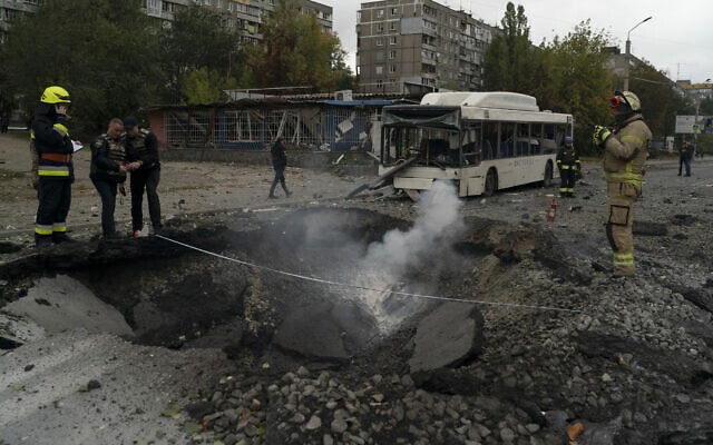 כוחות כיבוי אש ומשטרה ברחוב שנפגע מטילים בהתקפה הרוסית בדניפרו, אוקראינה, 10 באוקטובר 2022 (צילום: AP Photo/Leo Correa)