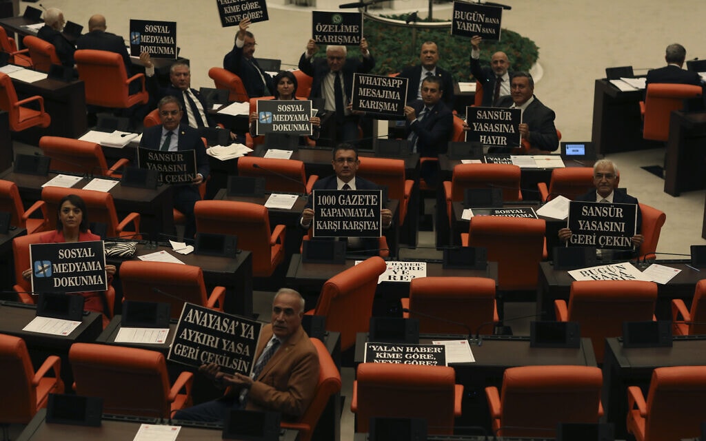 חברי האופוזיציה בפרלמנט הטורקי אוחזים בשלטי מחאה בעקבות העברת &quot;חוק התקשורת&quot;, 11 באוקטובר 2022 (צילום: AP Photo/Burhan Ozbilici)