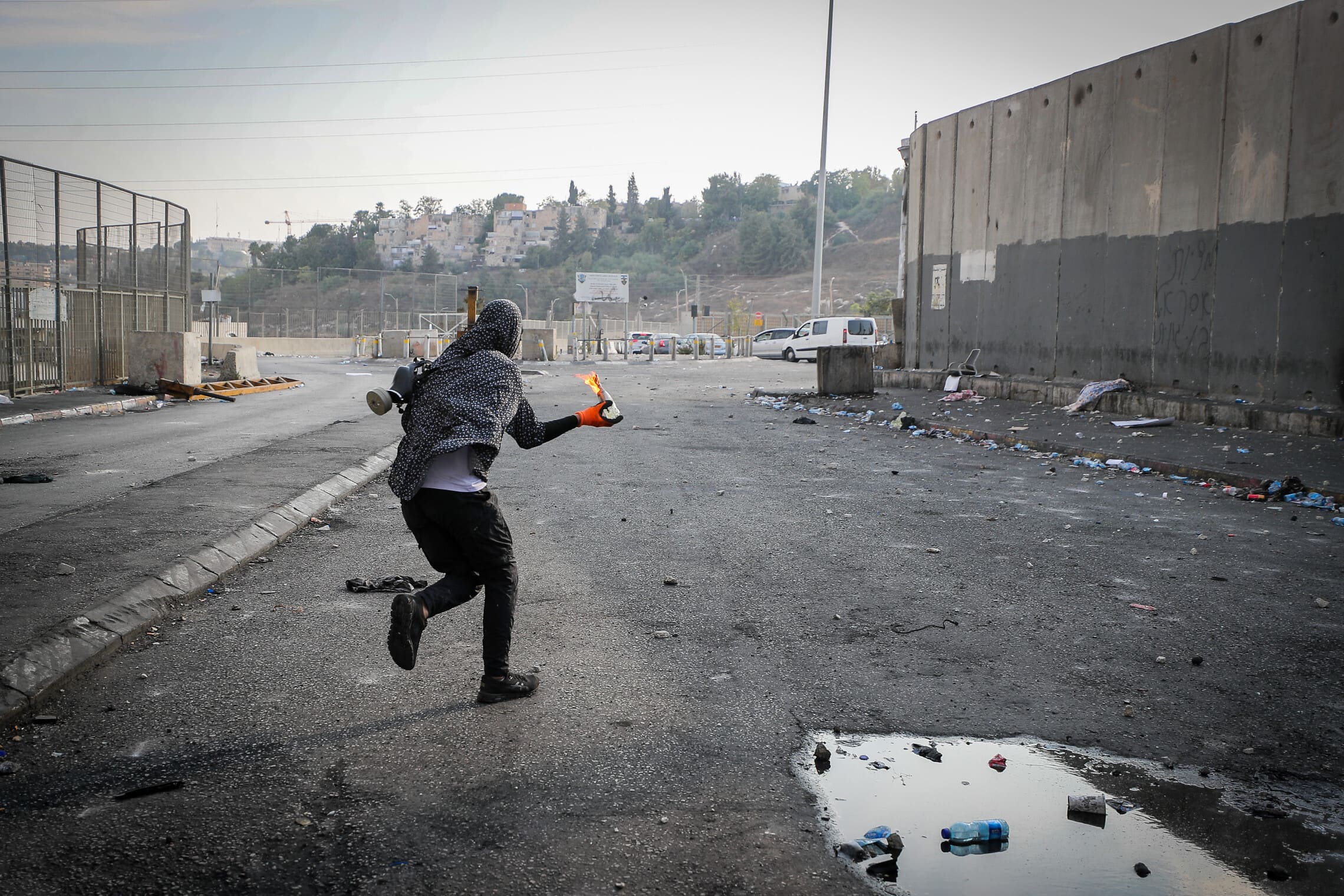 צעיר פלסטיני משליך בקבוק תבערה במחנה הפליטים שועפאט, 12 באוקטובר 2022 (צילום: Jamal Awad/Flash90)