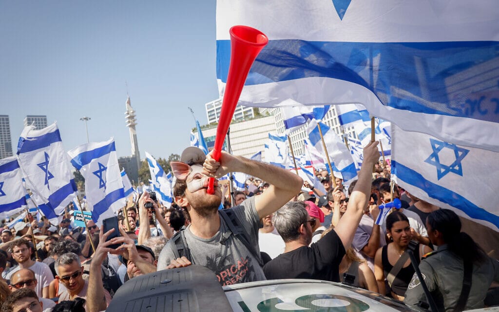 מפגין במסיכת חזיר תוקע בחצוצרת פלסטיק בהפגנה בתל אביב, 1 במרץ 2023 (צילום: Erik Marmor/Flash90)