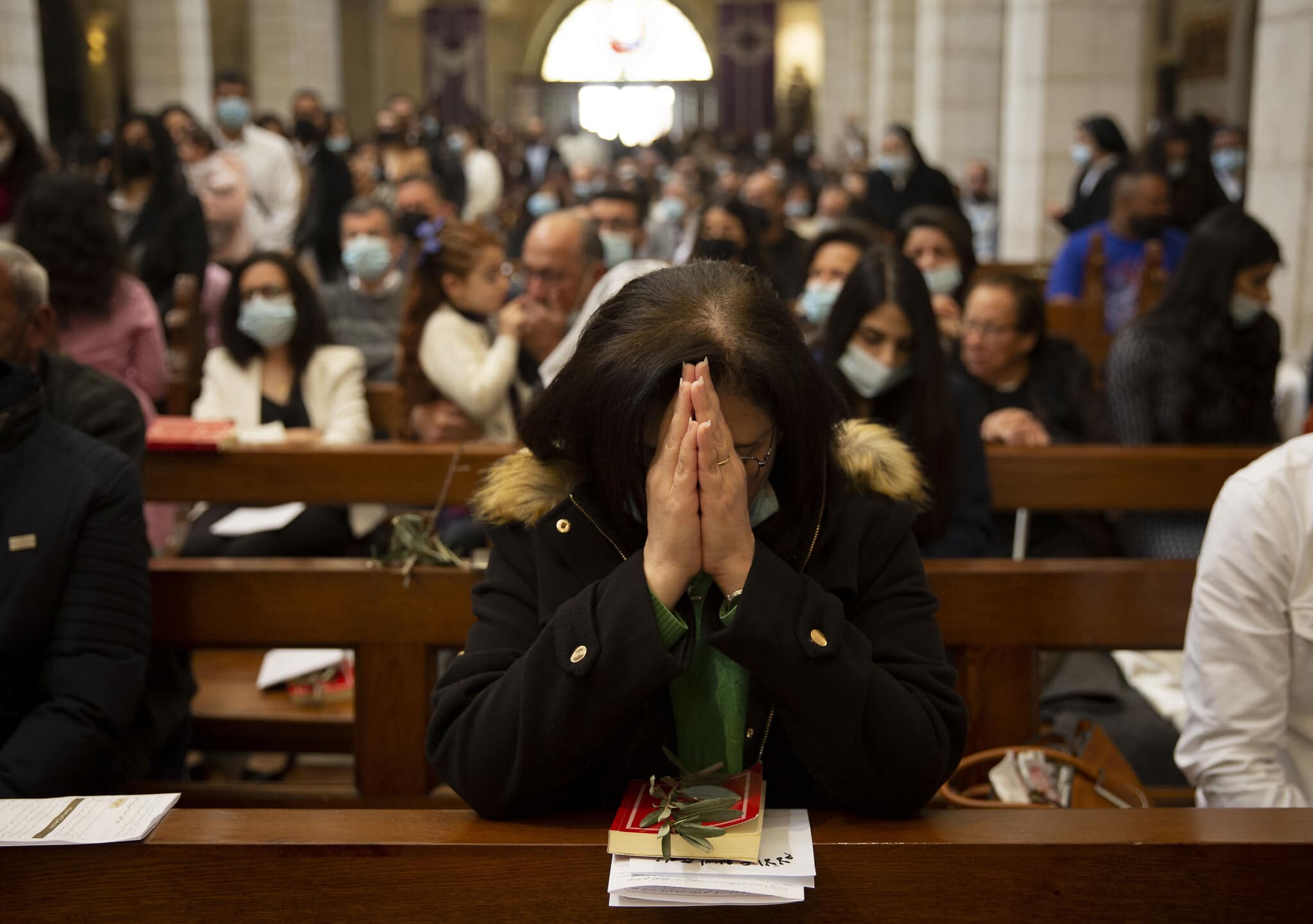 אנשים משתתפים במיסה ביום ראשון בכנסיית המולד בבית לחם, 28 במרץ 2021 (צילום: AP Photo/Majdi Mohammed)