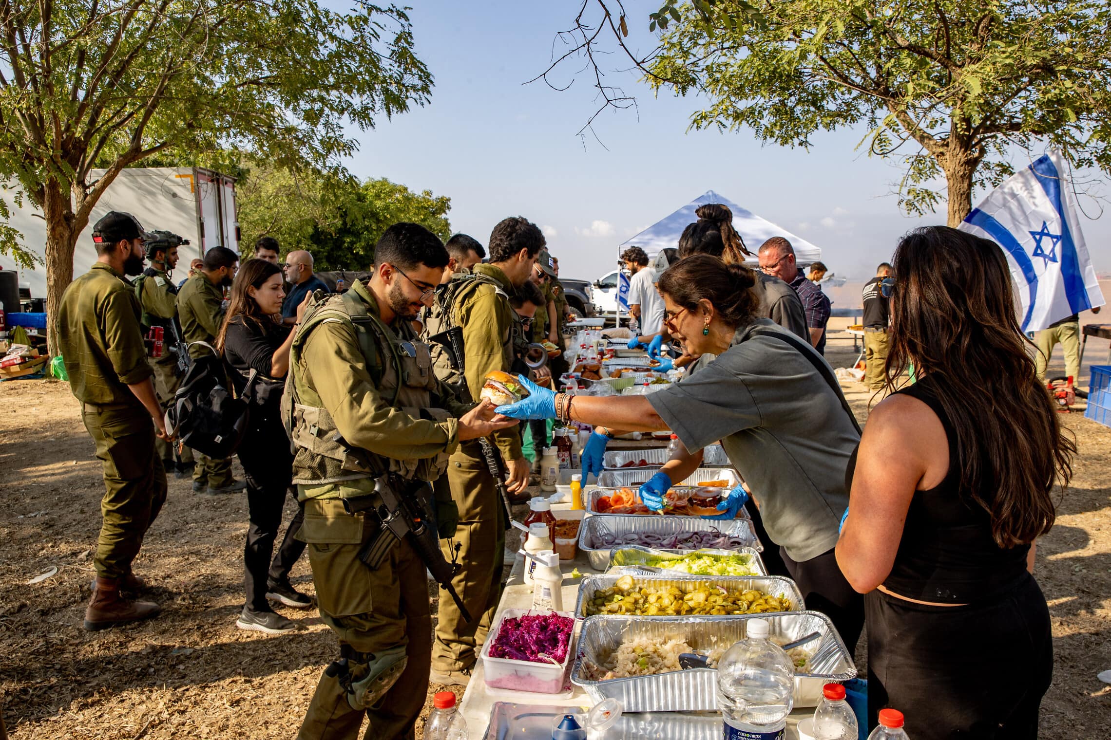 מתנדבים ישראלים מאכילים חיילים על גבול עזה. (צילום: Oren Ben Hakoon/Flash90)