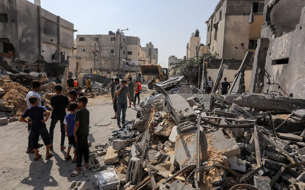 פלסטינים ליד מבנה שהופצץ על ידי צה&quot;ל ברפיח. 25 באוקטובר 2023 (צילום: Abed Rahim Khatib/Flash90)