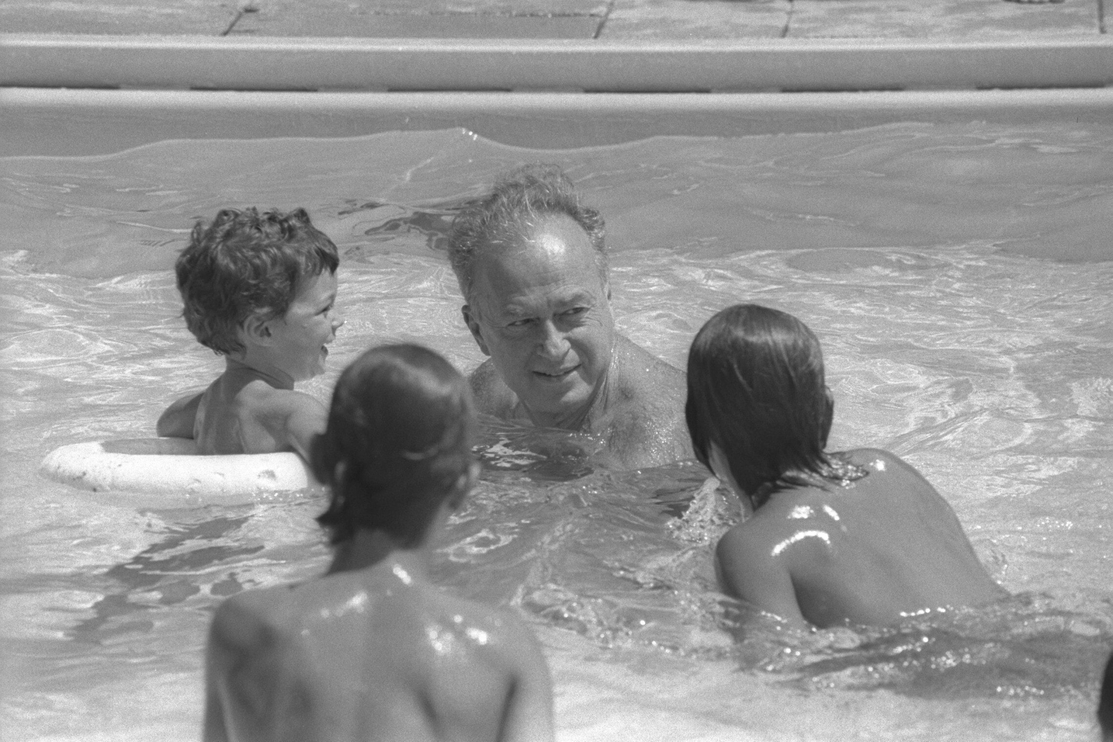 ראש הממשלה יצחק רבין בבריכה של מלון קיסריה עם נכדו יונתן, 1976 (צילום: יעקב סער, לע&quot;מ)