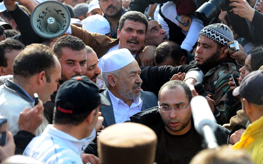 ראשד אל־גנושי, מנהיג התנועה האסלאמית של תוניסיה, מנופף לקהל עם הגעתו לנמל התעופה של תוניס, 30 בינואר 2011 (צילום: FETHI BELAID / AFP)