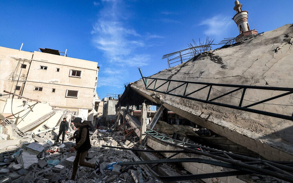 פלסטינים באתר ברפיח שנפגע בתקיפה ישראלית, 14 בפברואר 2024 (צילום: MOHAMMED ABED / AFP)