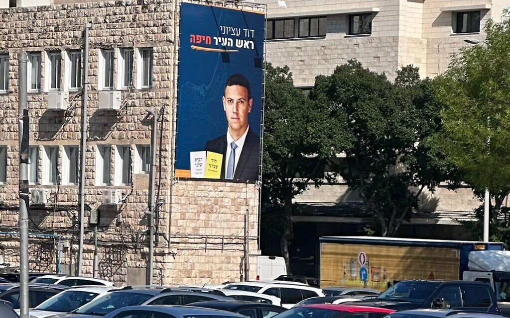 שלט בחירות של דוד עציוני על בניין בחיפה
