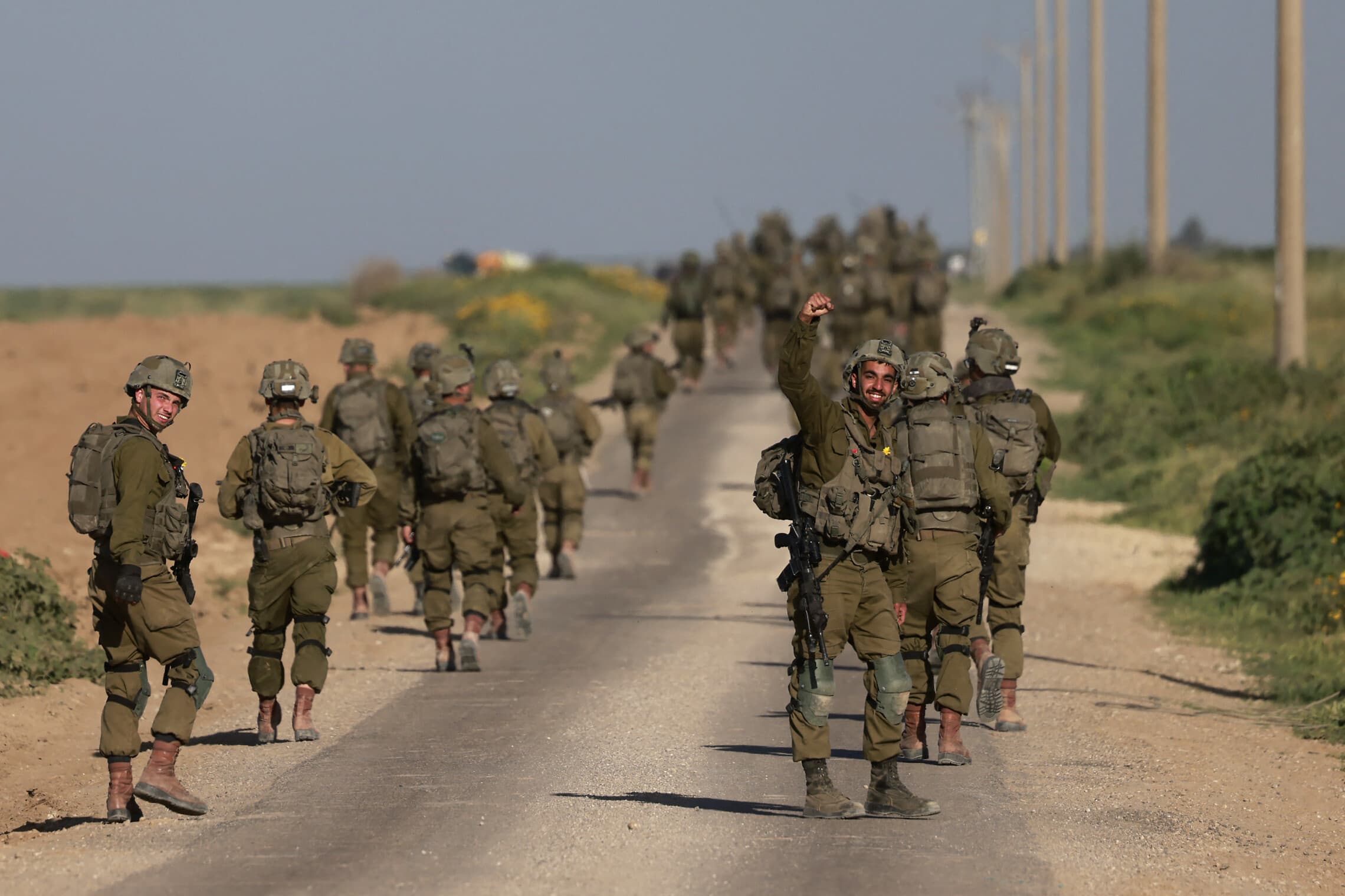 חיילי צה&quot;ל צועדים לאורך הגבול עם עזה, מרץ 2024 (צילום: Menahem KAHANA / AFP)