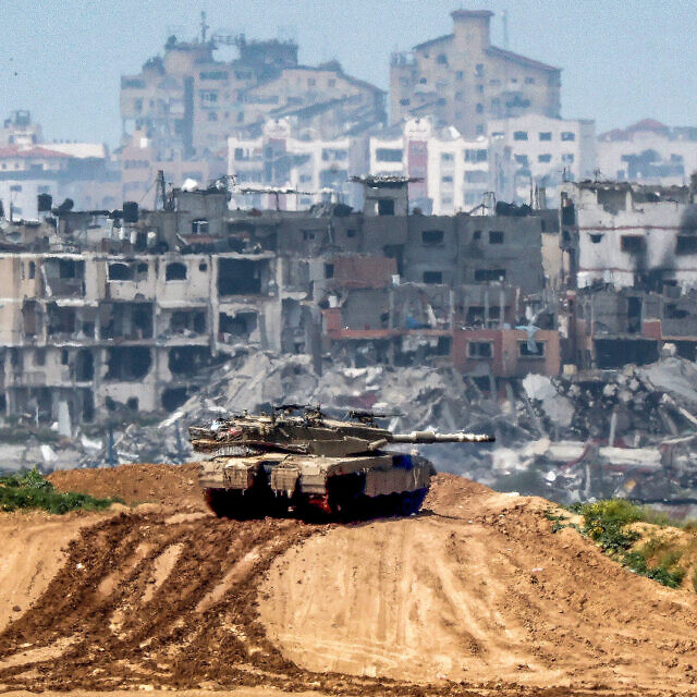 טנק ישראלי על רקע ההריסות בעזה, 19 במרץ 2024 (צילום: JACK GUEZ / AFP)