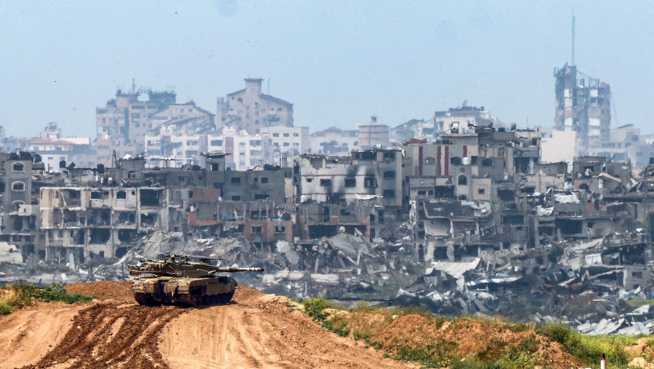 טנק ישראלי על רקע ההריסות בעזה, 19 במרץ 2024 (צילום: ACK GUEZ / AFP)