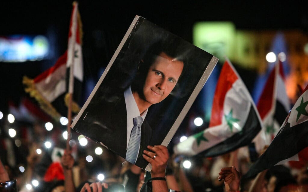דיוקן נשיא סוריה בשאר אל־אסד מונף בדמשק, 27 במאי 2021 (צילום: LOUAI BESHARA / AFP)