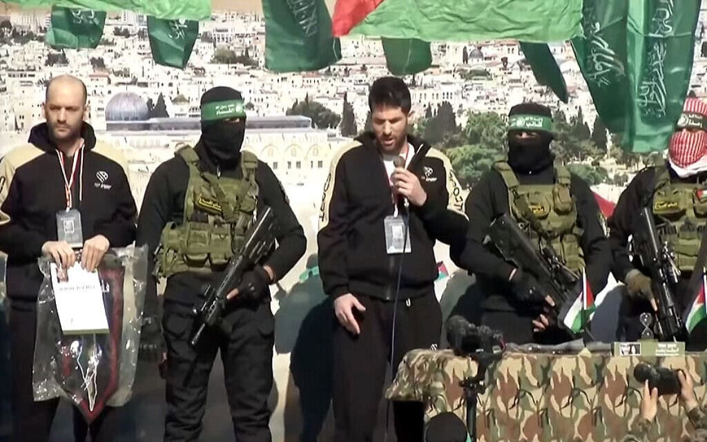 שגיא דקל חן על הבמה שהקים חמאס בחאן יונס לפני שיועבר לצלב האדום, 15 בפברואר 2025 (צילום: צילום מסך) שגיא דקל חן על הבמה שהקים חמאס בחאן יונס לפני שיועבר לצלב האדום, 15 בפברואר 2025 (צילום: צילום מסך)