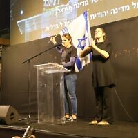 שקמה ברסלר מניפה דגל ישראל בעצרת נגד הממשלה בכיכר הבימה בתל אביב, 20 בדצמבר 2025 (צילום: גלעד פירסט, משמר הדמוקרטיה הישראלית) שקמה ברסלר מניפה דגל ישראל בעצרת נגד הממשלה בכיכר הבימה בתל אביב, 20 בדצמבר 2025 (צילום: גלעד פירסט, משמר הדמוקרטיה הישראלית)