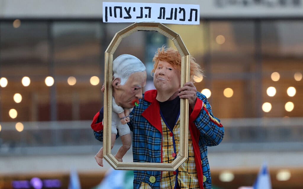 מפגין מחופש לנשיא ארה"ב דונלד טראמפ מחזיק בובת תינוק בדמותו של ראש הממשלה בנימין נתניהו במהלך הפגנה נגד הממשלה והמלחמה במזרח התיכון, בכיכר הבימה בתל אביב, 16 במאי 2026 (צילום: Jack GUEZ / AFP) מפגין מחופש לנשיא ארה"ב דונלד טראמפ מחזיק בובת תינוק בדמותו של ראש הממשלה בנימין נתניהו במהלך הפגנה נגד הממשלה והמלחמה במזרח התיכון, בכיכר הבימה בתל אביב, 16 במאי 2026 (צילום: Jack GUEZ / AFP)