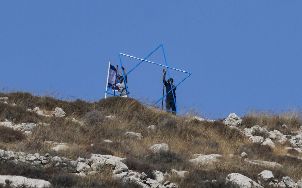 מתנחלים ישראלים מקימים מאחז חדש בכפר הפלסטיני עזמוט שבגדה המערבית הכבושה. 17 ביולי 2026 (צילום: Jaafar ASHTIYEH / AFP) מתנחלים ישראלים מקימים מאחז חדש בכפר הפלסטיני עזמוט שבגדה המערבית הכבושה. 17 ביולי 2026 (צילום: Jaafar ASHTIYEH / AFP)