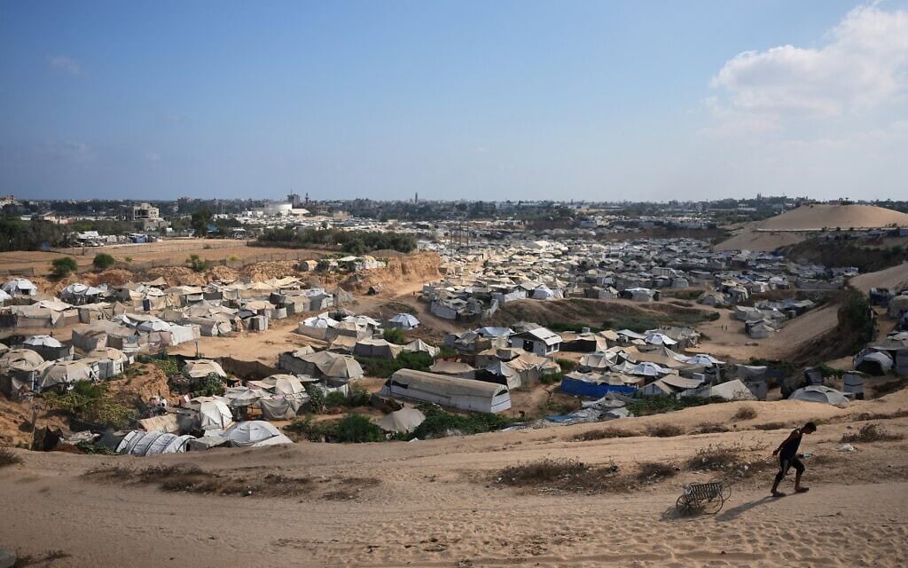 גבר פלסטיני גורר עגלה ריקה לצד מחנה עקורים ארעי רחב ידיים בדיר אל-בלח שבמרכז רצועת עזה (צילום: AP Photo/Abdel Kareem Hana) גבר פלסטיני גורר עגלה ריקה לצד מחנה עקורים ארעי רחב ידיים בדיר אל-בלח שבמרכז רצועת עזה (צילום: AP Photo/Abdel Kareem Hana)